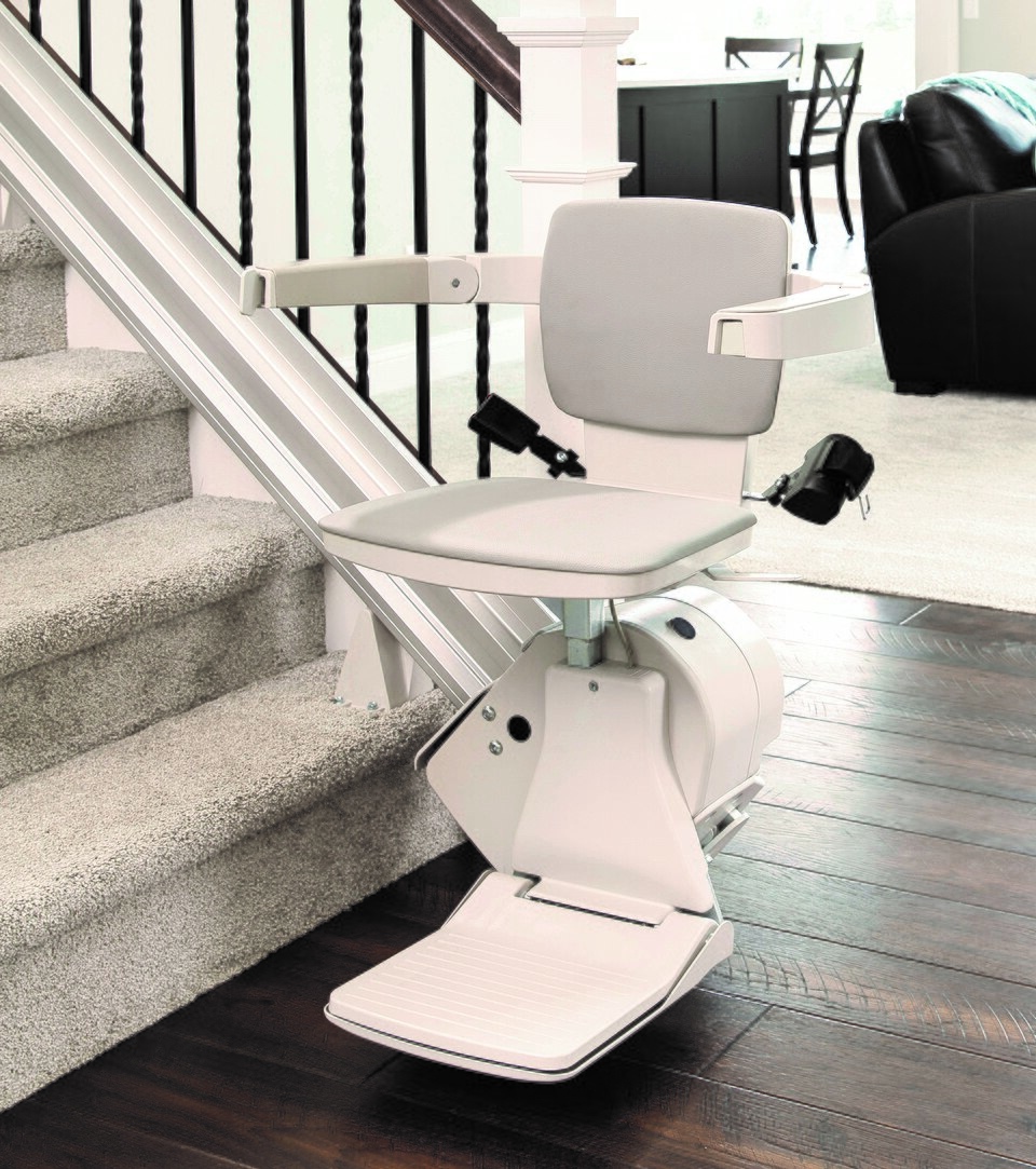 Example of a seated straight stair lift beside an indoor staircase